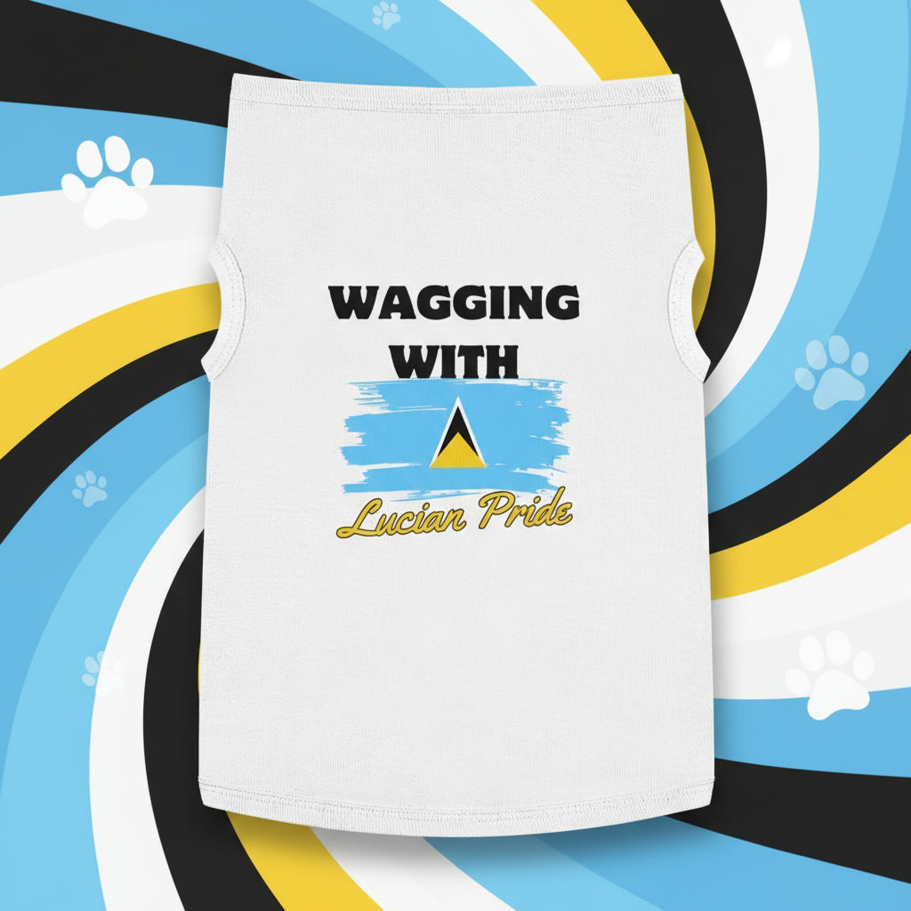 A dog wearing a gray tank top with 'WAGGING WITH LUCIAN PRIDE' printed on the front, featuring the St. Lucian flag.