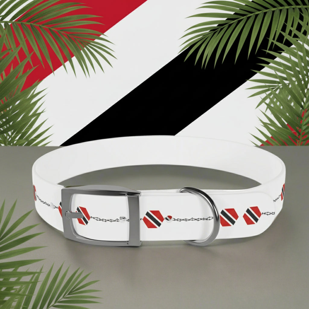 White dog collar with red and black patterns on a gray surface with a blurred plant background
