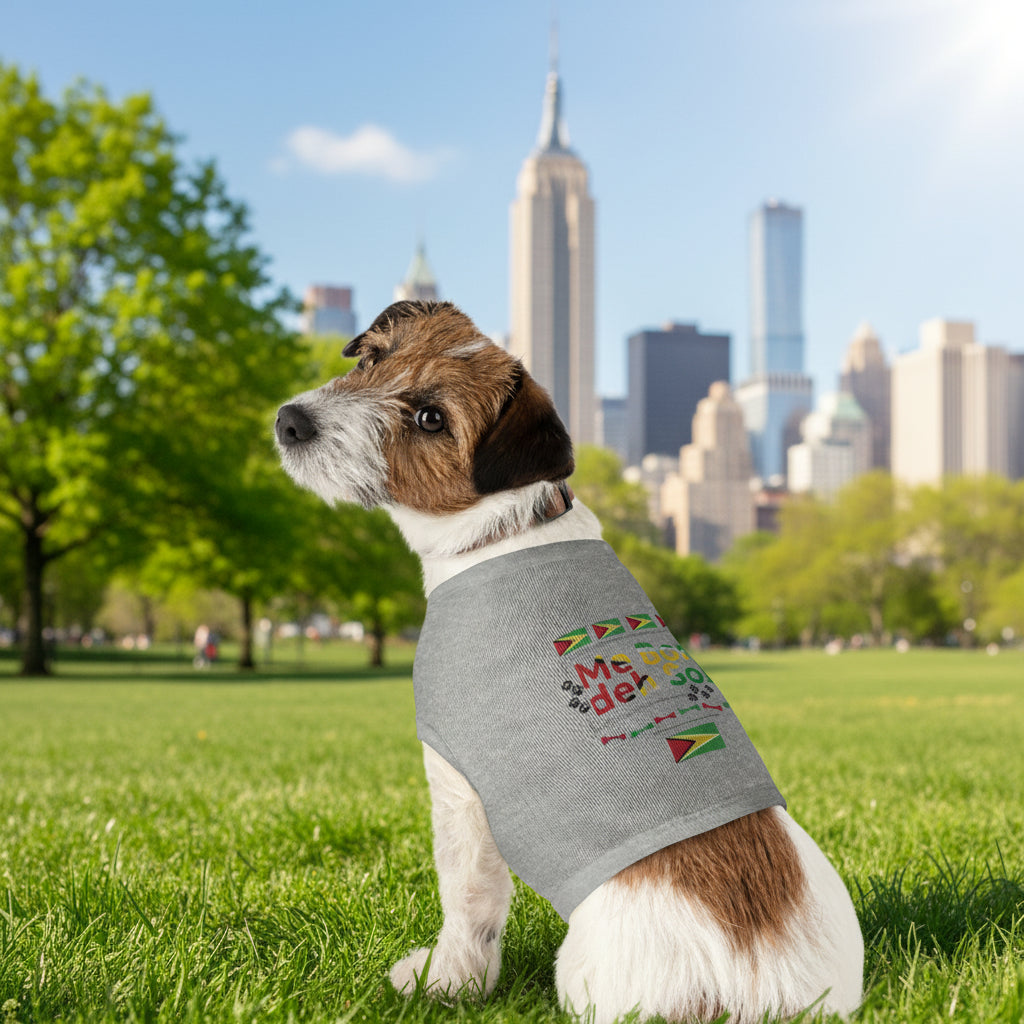Dog wearing a gray sleeveless shirt with colorful text and graphics on a white background
