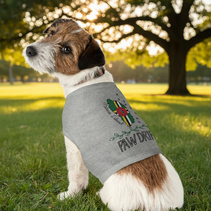 Dog wearing a gray shirt with a logo and text in a park