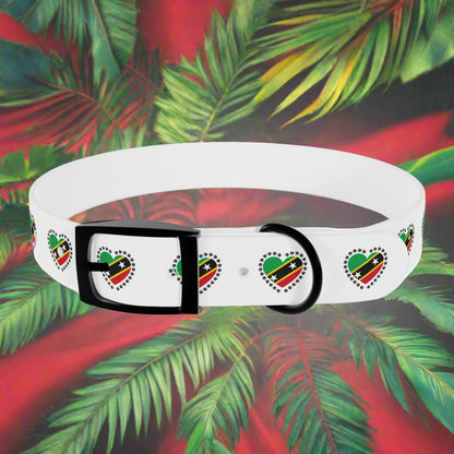 White dog collar with black buckle and heart designs on a tropical leaf background
