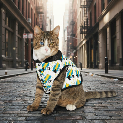Cat wearing a colorful patterned harness on a white background