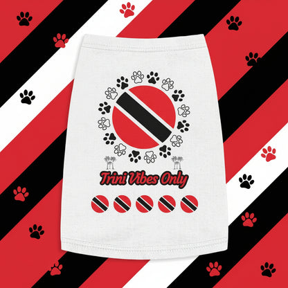 White towel with Trini flag design and 'Trini Vibes Only' text on a wooden surface with green leaves.