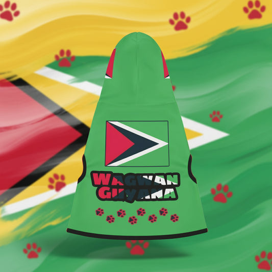 A green pet hoodie with the Guyana flag colors and the text 'Wagwan Guyana' on the back, laid out on a sandy surface.