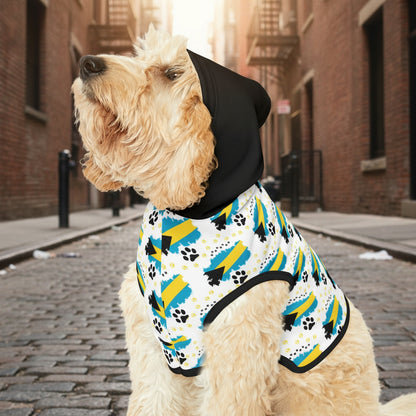 Dog wearing a colorful patterned shirt with black trim on a white background
