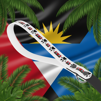 White dog leash with colorful paw print design on a beach background